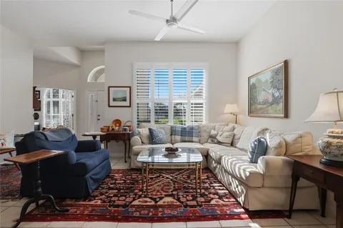 a living room with furniture wooden floor and a large window