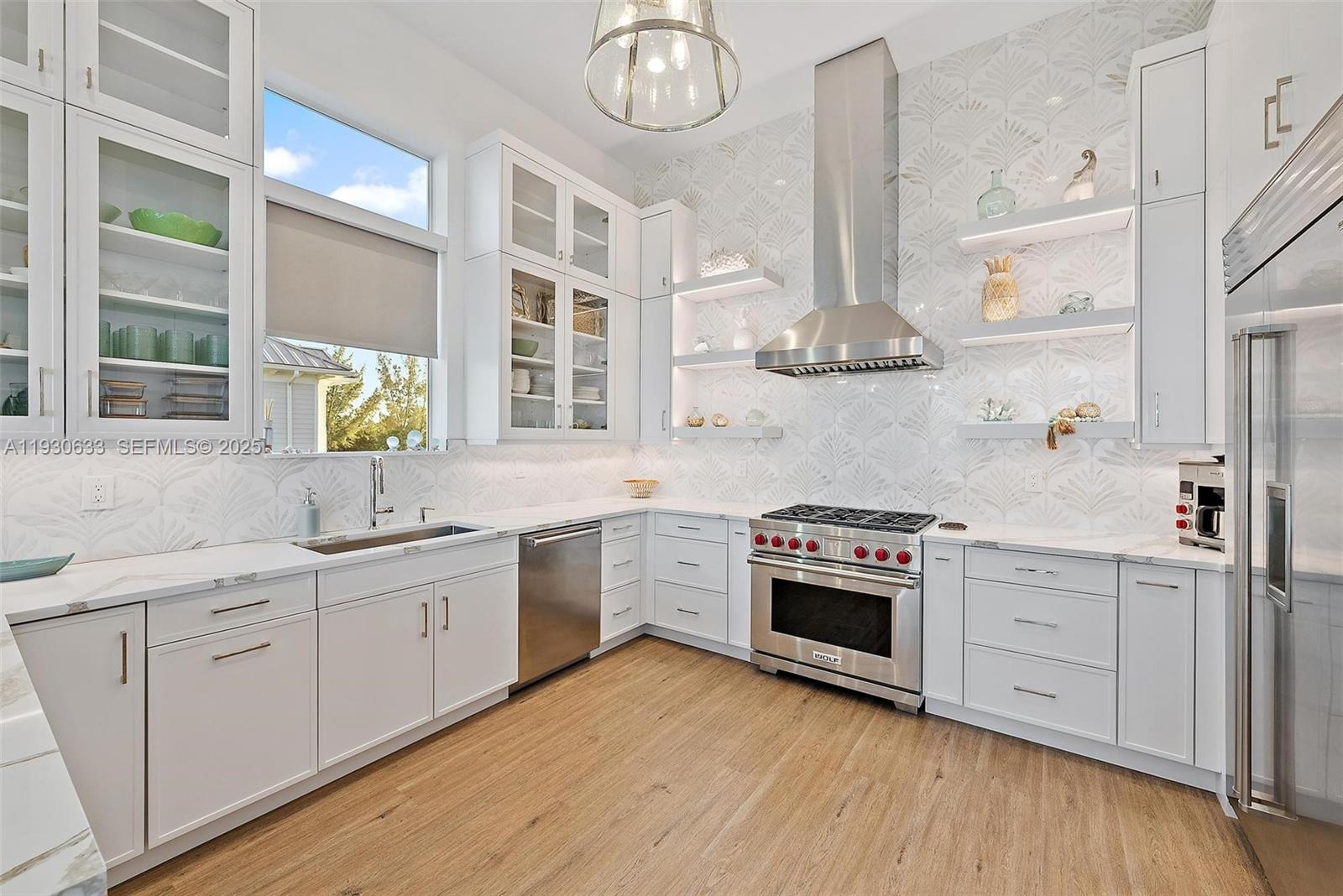 5128 Watersong Way Fort Pierce, FL 34949 - Photo 11 of 42 Kitchen wit Italian decorative tile, Sub-Zero, Wolf