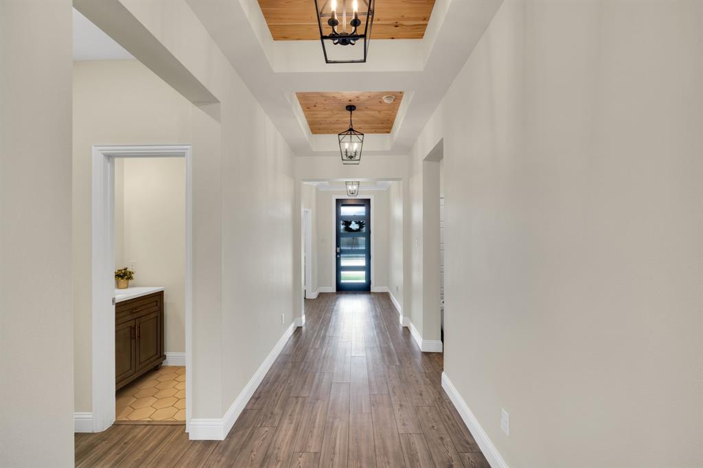 1601 Bear Path Way Gunter, TX 75058 - Photo 9 of 40 a view of a hallway with wooden floor and a cabinet