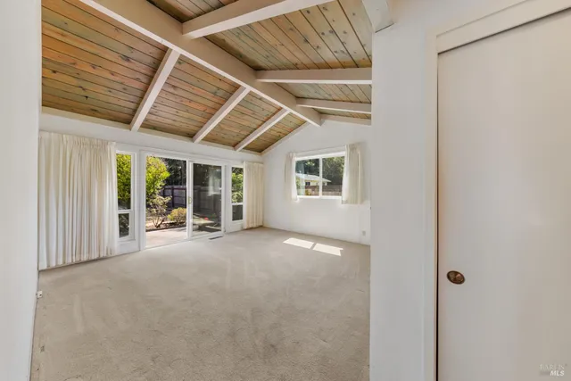 a bedroom with a large bed and a balcony