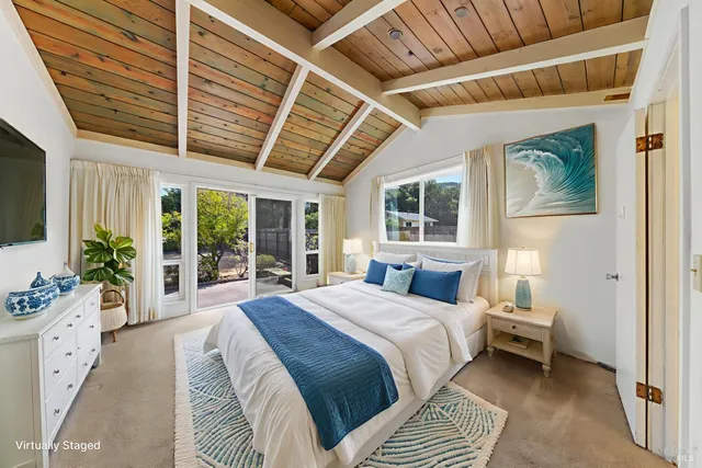 a view of a porch with chairs and floor to ceiling window