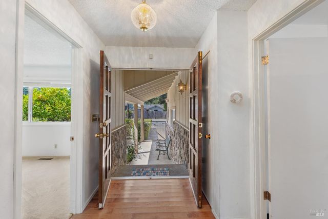 a view of hallway with kitchen view and living room