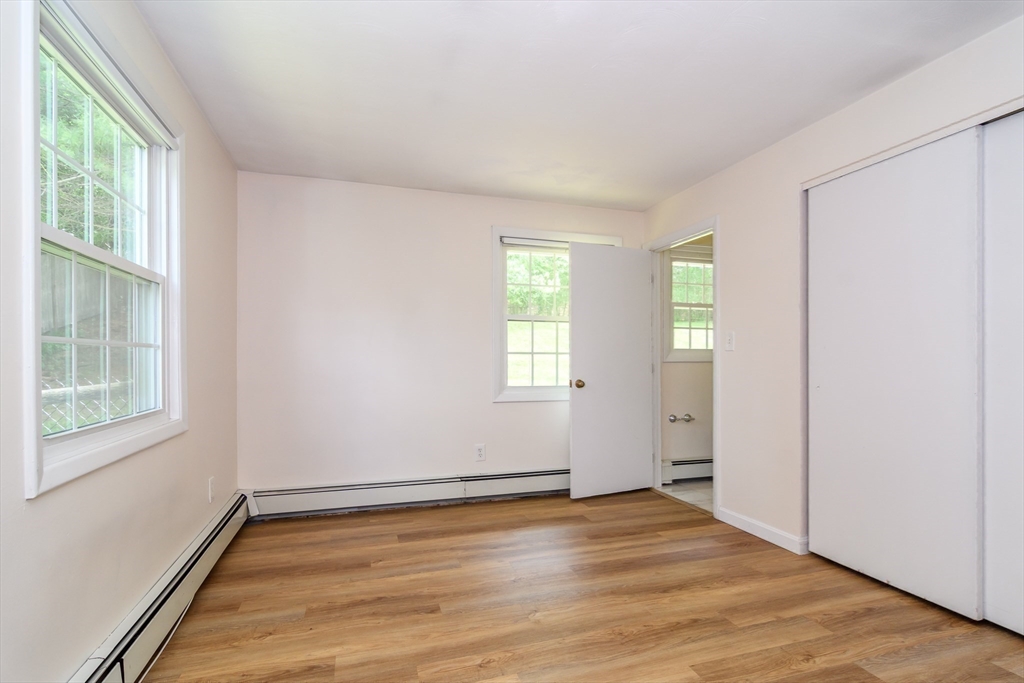 33 Eisenhower Road Framingham, MA 01701 - Photo 15 of 20 an empty room with wooden floor and windows
