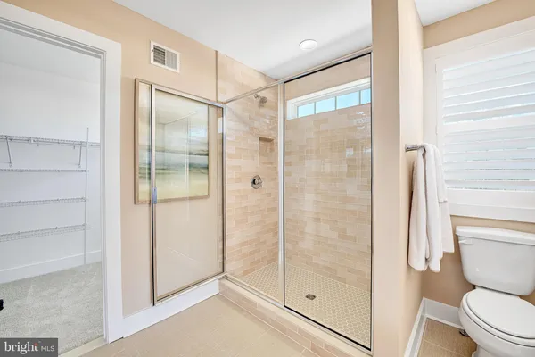 a bathroom with a shower and toilet