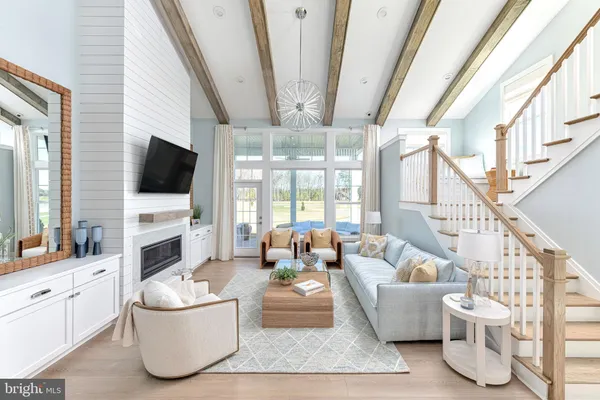 a living room with furniture a flat screen tv and a large window