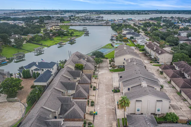 an aerial view of house with yard and ocean view