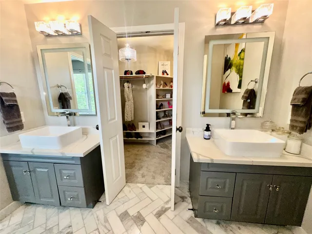 a bathroom with a sink mirror and shower