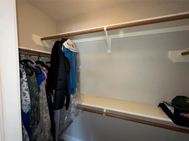 a view of a room with a fan and a window