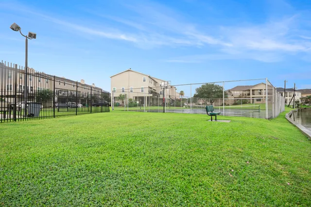 a view of a house with a backyard and plants