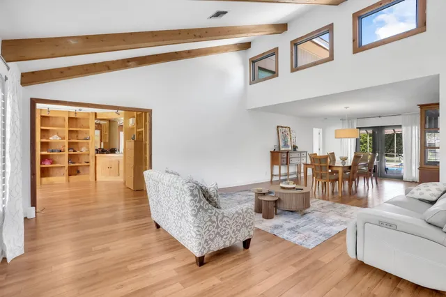a view of a backyard with table and chairs under an umbrella