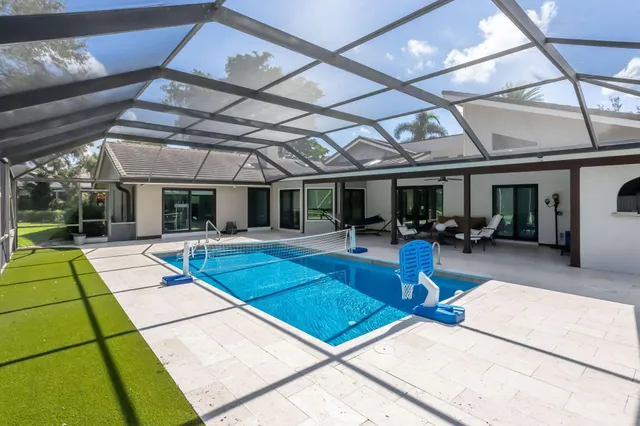 a view of a room with wooden floor and furniture