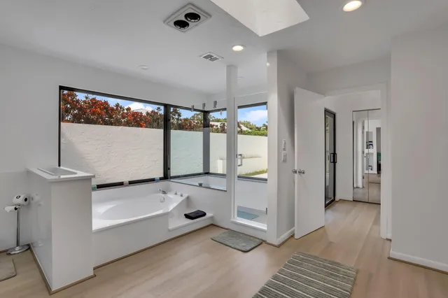 an aerial view of residential houses with outdoor space and trees