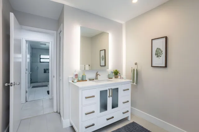 a view of a patio with table and chairs potted plants with wooden floor