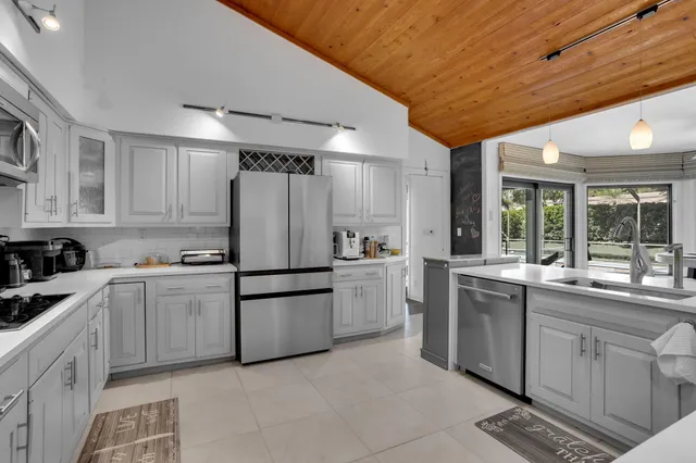 a dining room with furniture and a large window
