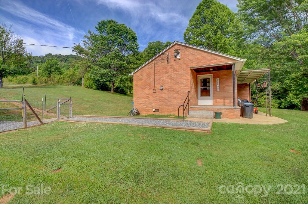 232 P P V Road Clyde, NC 28721 - Photo 12 of 22 a view of a backyard with a garden and entertaining space