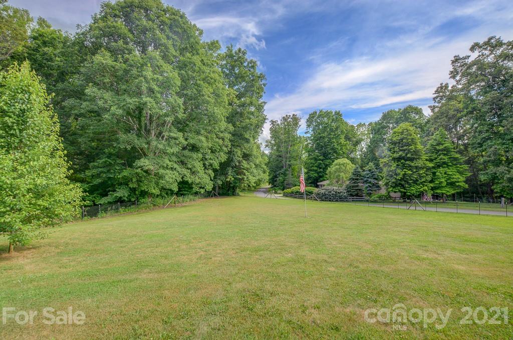 232 P P V Road Clyde, NC 28721 - Photo 18 of 22 a view of a field with an trees in the background