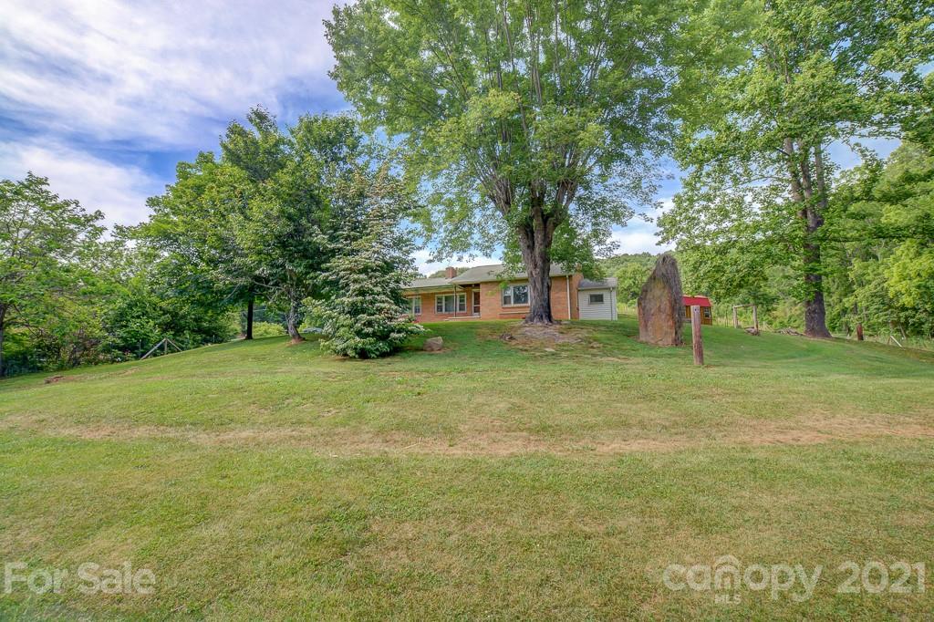 232 P P V Road Clyde, NC 28721 - Photo 19 of 22 a view of a house with a yard
