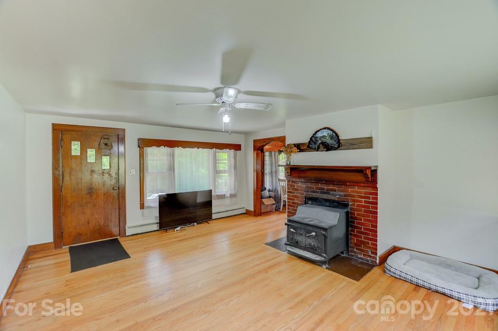 232 P P V Road Clyde, NC 28721 - Photo 3 of 22 a living room with furniture and a fireplace