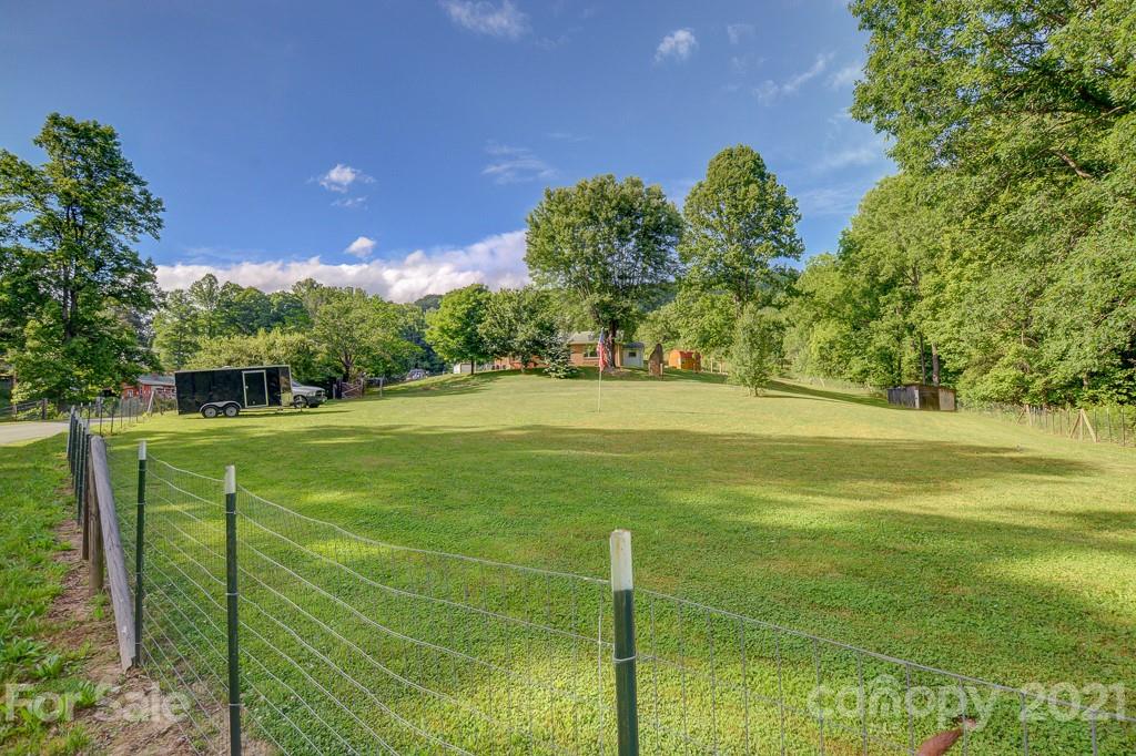 232 P P V Road Clyde, NC 28721 - Photo 22 of 22 a view of a golf course with a trees