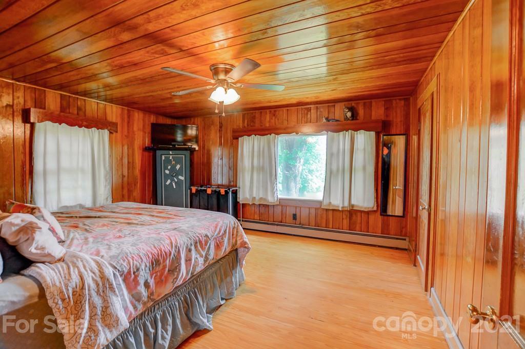 232 P P V Road Clyde, NC 28721 - Photo 6 of 22 a bedroom with a bed and large windows