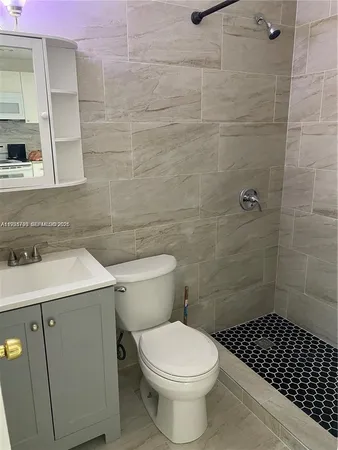 a kitchen with stainless steel appliances granite countertop a refrigerator sink and white cabinets