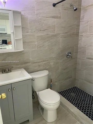 a kitchen with stainless steel appliances granite countertop a refrigerator sink and white cabinets