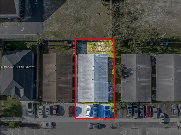 an aerial view of residential houses with outdoor space