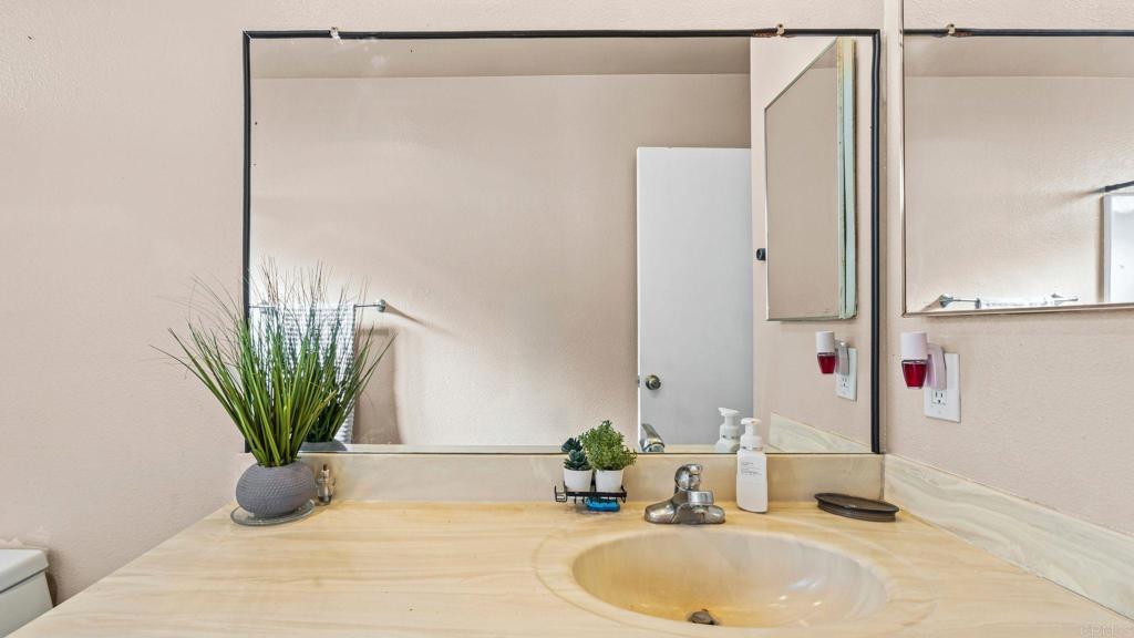 8146 Lemon Grove Way, Unit B Lemon Grove, CA 91945 - Photo 18 of 28 a bathroom with a sink a mirror and a potted plant