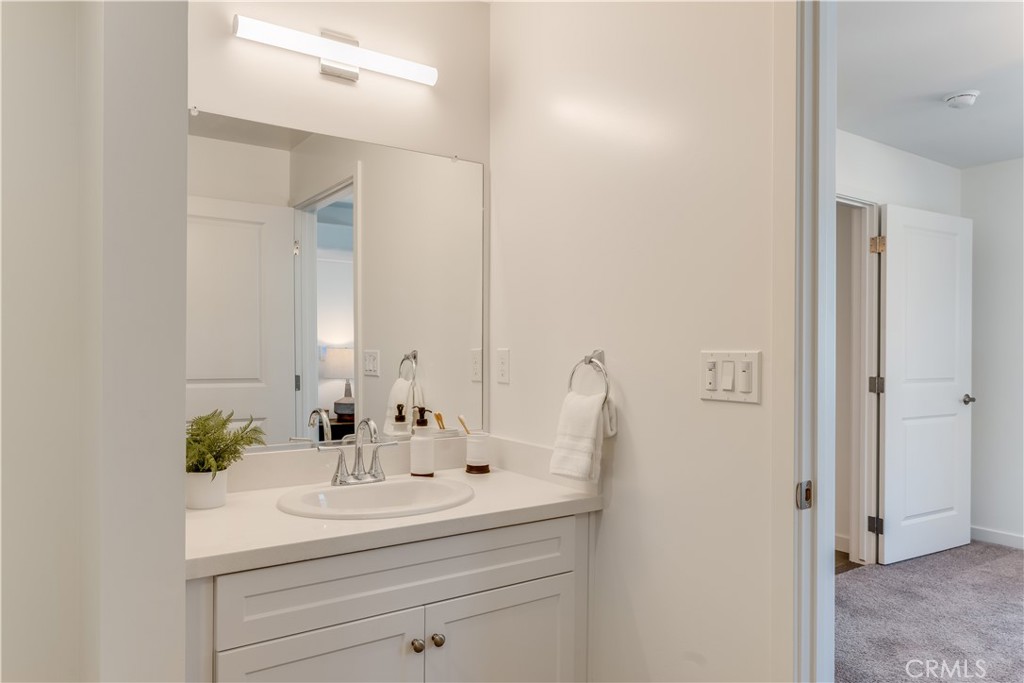 3802 Ranch House Road, Unit 103 San Luis Obispo, CA 93401 - Photo 5 of 9 a bathroom with a sink and a mirror