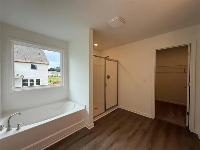 a bathroom with a bathtub and a shower