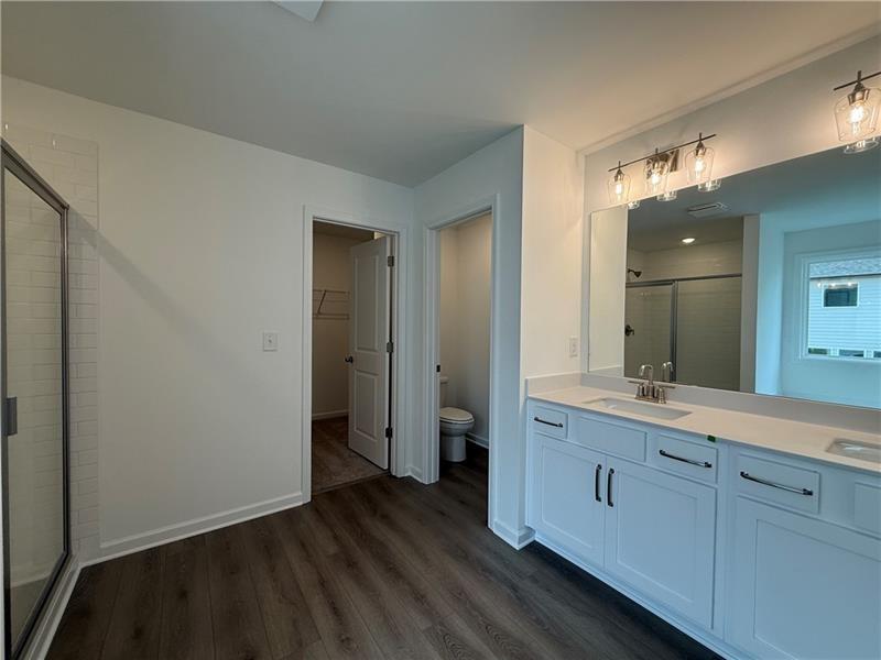 5449 Hargrove Way Flowery Branch, GA 30542 - Photo 23 of 39 a bathroom with a double vanity sink and mirror