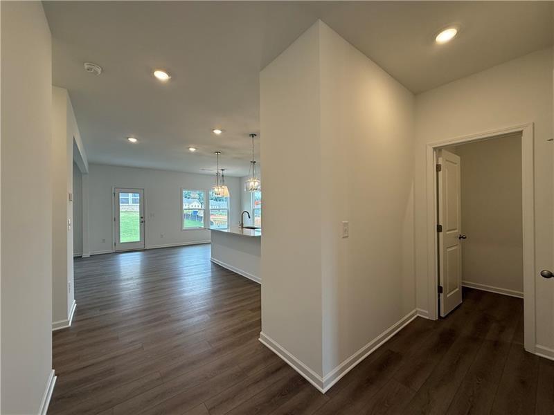 5449 Hargrove Way Flowery Branch, GA 30542 - Photo 5 of 39 an empty room with wooden floor and windows