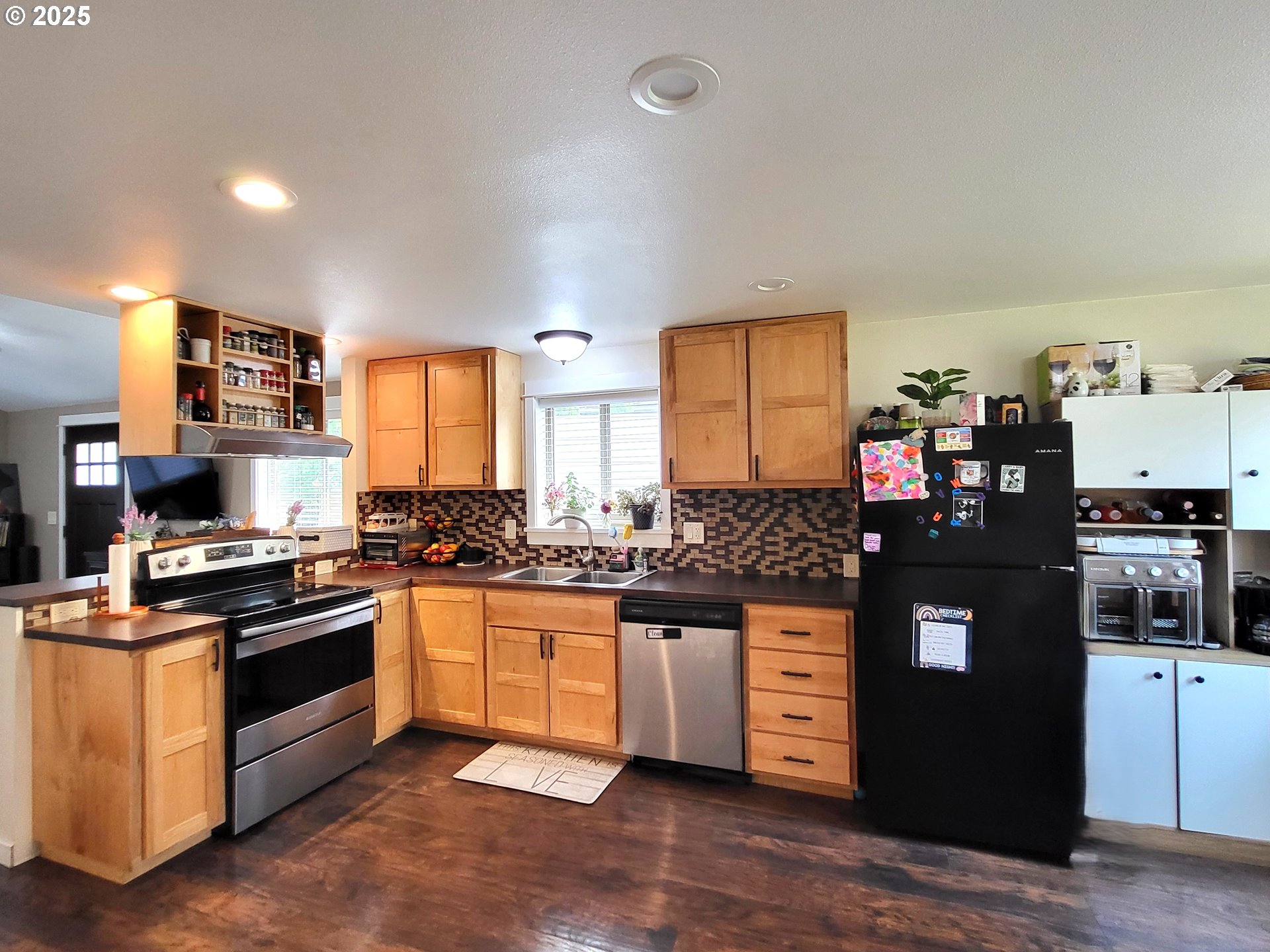 1727 East Washington Avenue Cottage Grove, OR 97424 - Photo 5 of 20 a kitchen with stainless steel appliances granite countertop a stove and a sink