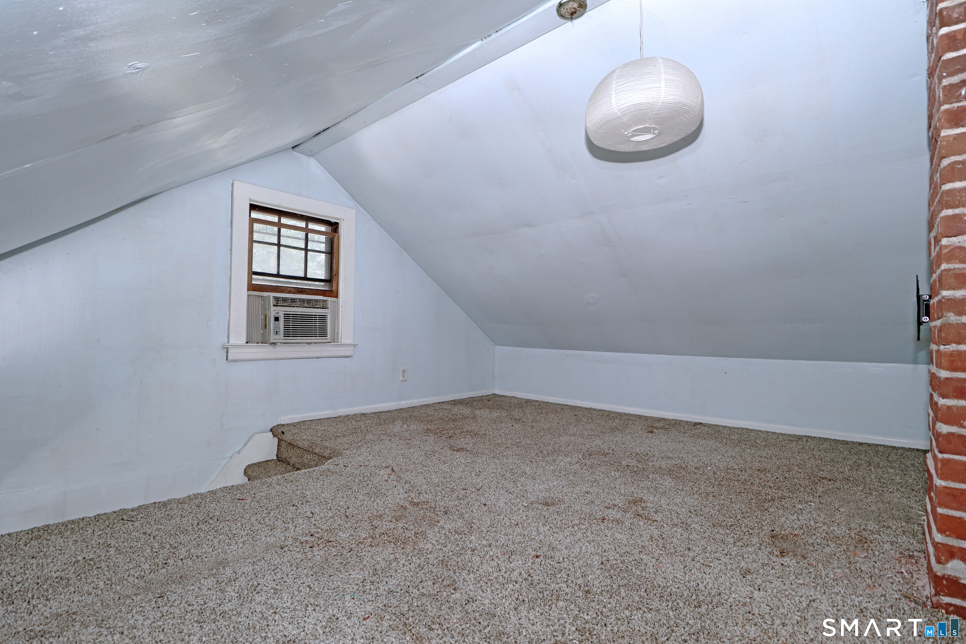 104 Henderson Road Fairfield, CT 06824 - Photo 21 of 26 Attic level finished room with wall to wall carpet.