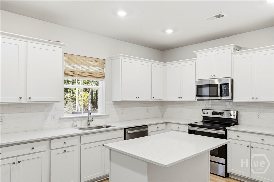 136 Binscombe Lane Pooler, GA 31322 - Photo 12 of 35 Gourmet Kitchen with Quartz Countertops, Island, and large single basin SS sink with Chef-Style Pull-Down Faucet