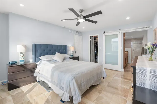 a bedroom with a bed and a large mirror