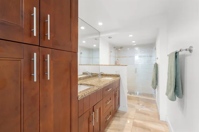 a bathroom with a double vanity sink and a shower