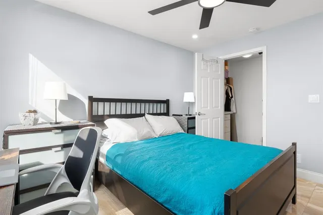 a bed room with a bed and a chair