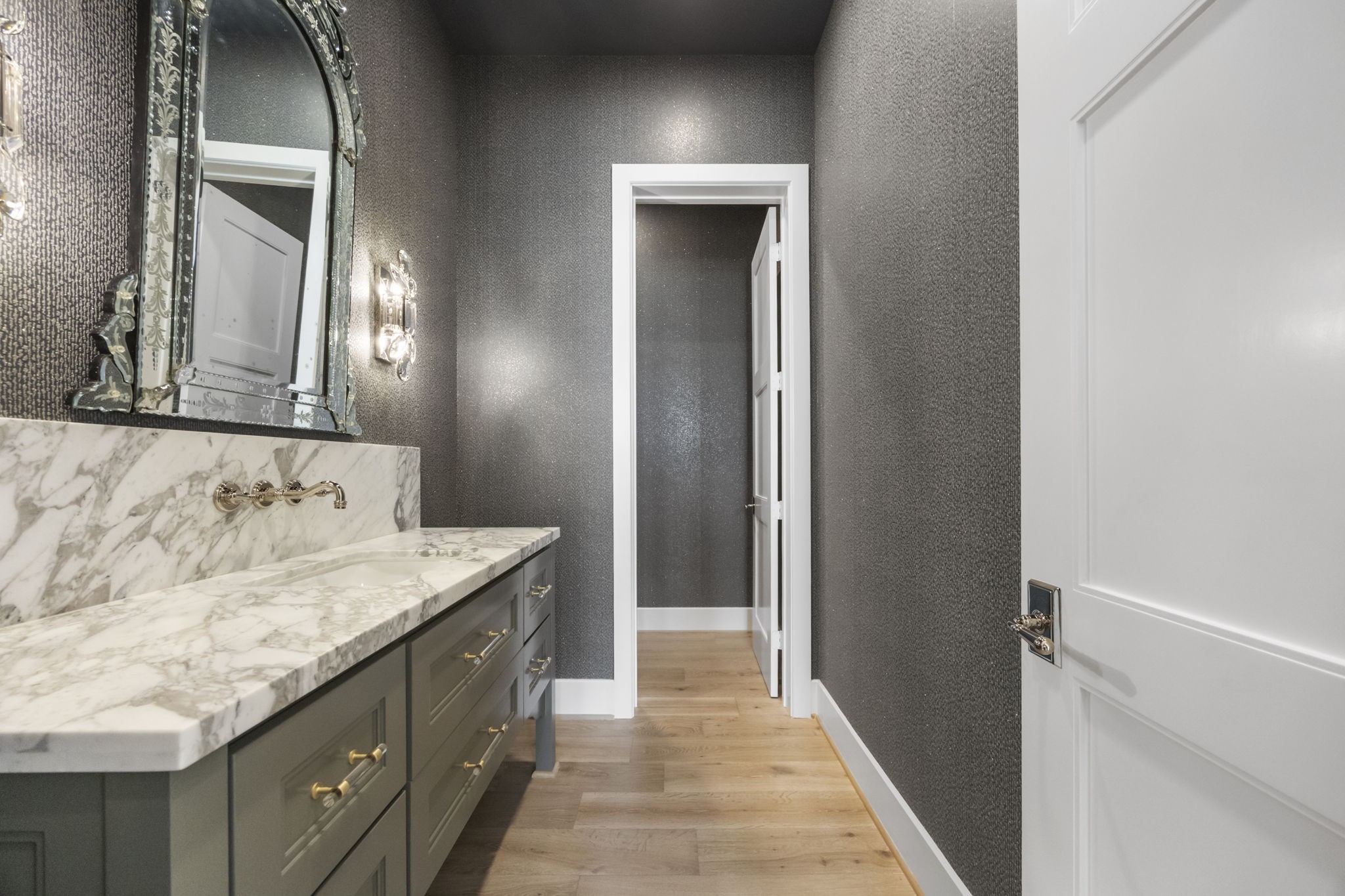 4233 Two Gun Way Katy, TX 77494 - Photo 37 of 47 Stunning powder room off entry with lux vanity, mirror, sconces, and wallpaper.