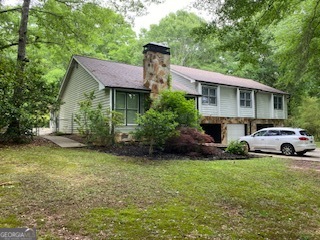 1117 Boss Hardy Road Auburn, GA 30011 - Photo 2 of 19 a view of a house with a garden