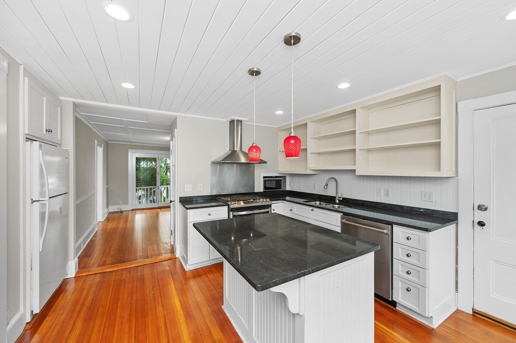 18 Bennett Street, Unit 2 Manchester, MA 01944 - Photo 3 of 21 a kitchen with a stove a sink and a refrigerator