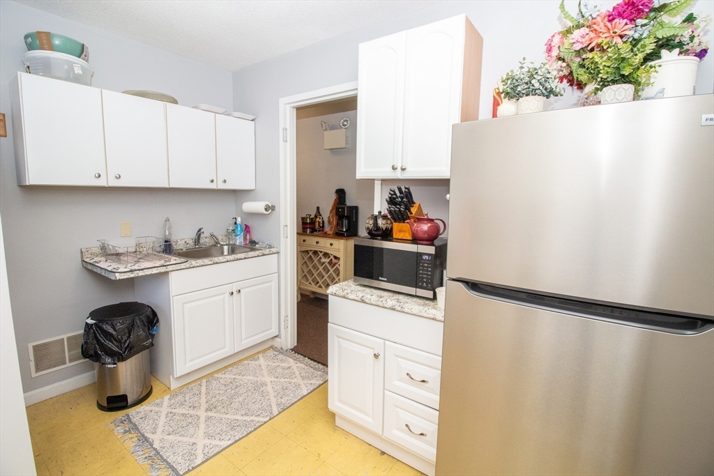 47 Sandwich Road Wareham, MA 02571 - Photo 15 of 22 a kitchen with a refrigerator and cabinets