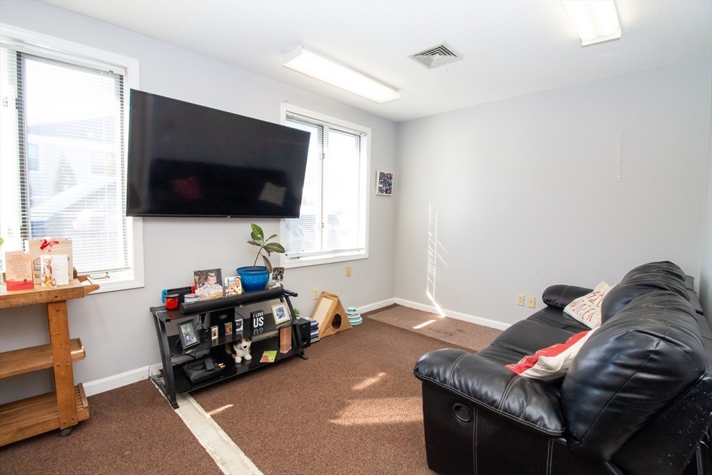 47 Sandwich Road Wareham, MA 02571 - Photo 8 of 22 a living room with furniture and a flat screen tv