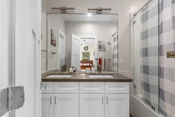 a bedroom with a bed lamp and a window