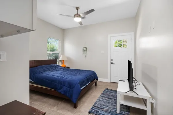 a bedroom with a bed and a flat screen tv