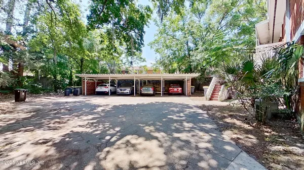 a view of house with outdoor space and car parked