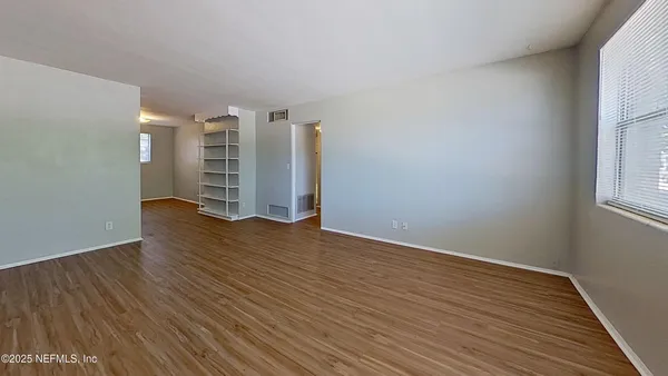 a view of wooden floor and windows in a room