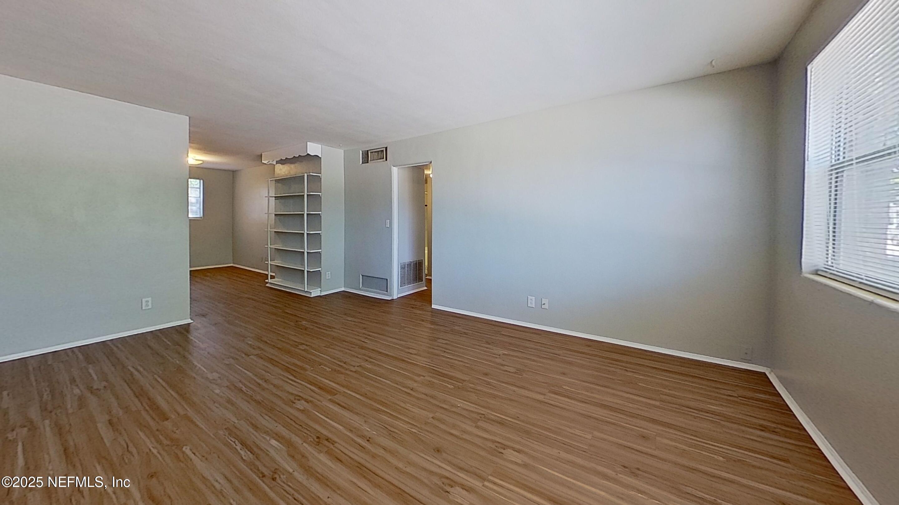 3034 Belden Street, Unit 3 Jacksonville, FL 32207 - Photo 2 of 13 a view of wooden floor and windows in a room