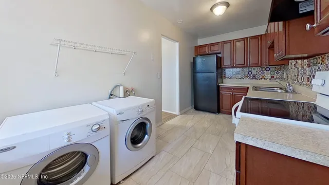 a utility room with sink dryer and washer