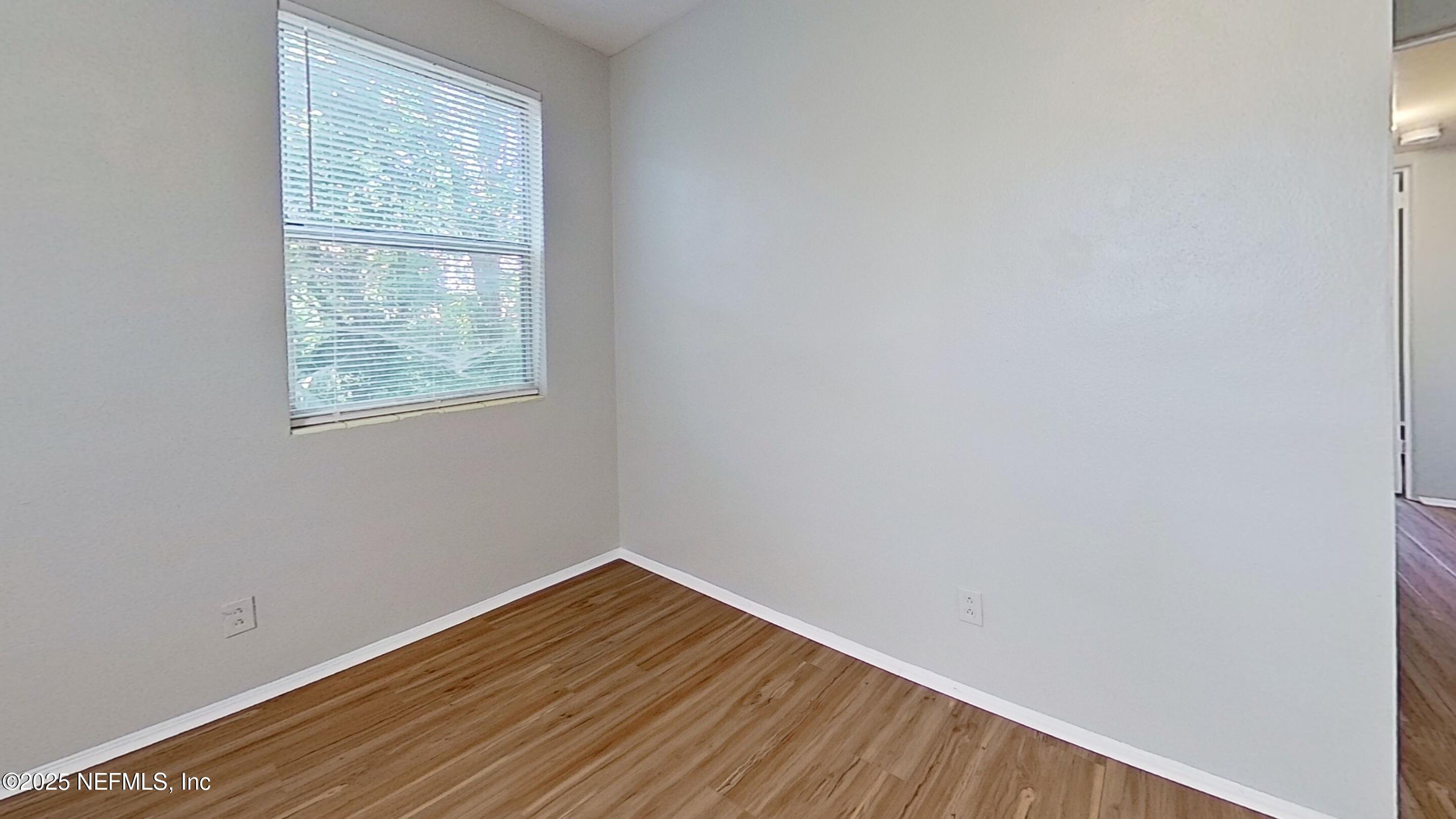 3034 Belden Street, Unit 3 Jacksonville, FL 32207 - Photo 9 of 13 a view of an empty room with wooden floor and a window